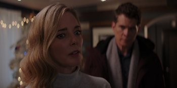 Movie still from “I Believe in Santa” (2022), directed by Alex Ranarivelo – A man and a woman are looking at the camera; Close Up shot, Over the shoulder angle