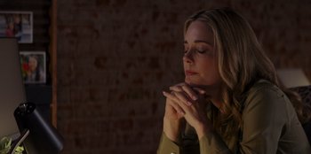 Movie still from “I Believe in Santa” (2022), directed by Alex Ranarivelo – A woman is praying with her eyes closed; Close Up shot, High angle