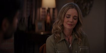 Movie still from “I Believe in Santa” (2022), directed by Alex Ranarivelo – A woman sitting in front of a lamp in a living room; Close Up shot, High angle