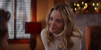 Movie still from “I Believe in Santa” (2022), directed by Alex Ranarivelo – A person sitting in a room; Close Up shot, Over the shoulder angle