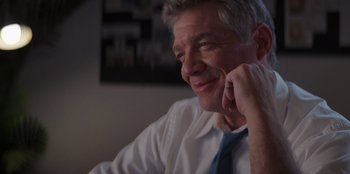 Movie still from “I Believe in Santa” (2022), directed by Alex Ranarivelo – A person wearing a shirt and a tie; Close Up shot, Over the shoulder angle