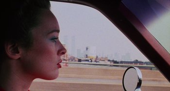 Movie still from “I Spit on Your Grave” (1978), directed by Meir Zarchi – A woman looking out of the window of a car; Close Up shot, Over the shoulder angle