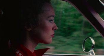 Movie still from “I Spit on Your Grave” (1978), directed by Meir Zarchi – A woman looking out the window of a car; Close Up shot, High angle