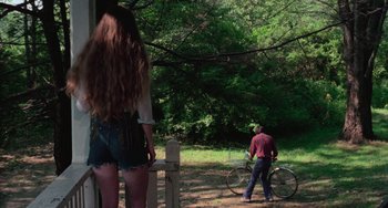Movie still from “I Spit on Your Grave” (1978), directed by Meir Zarchi – A man and a woman standing in the woods; Wide shot, Over the shoulder angle