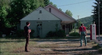Movie still from “I Spit on Your Grave” (1978), directed by Meir Zarchi – A man standing in front of an old house; Wide shot, Over the shoulder angle