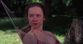 Movie still from “I Spit on Your Grave” (1978), directed by Meir Zarchi – A woman in a pink bathing suit is holding a stick; Close Up shot, Low angle