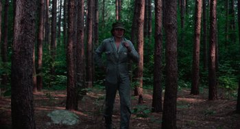 Movie still from “I Spit on Your Grave” (1978), directed by Meir Zarchi – A man standing in the middle of a forest; Wide shot, Low angle