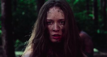 Movie still from “I Spit on Your Grave” (1978), directed by Meir Zarchi – A young woman with brown hair and red lipstick; Close Up shot, Low angle