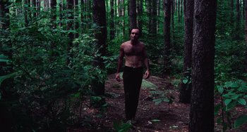 Movie still from “I Spit on Your Grave” (1978), directed by Meir Zarchi – A man standing in the middle of a forest; Medium shot, Low angle