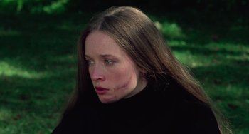 Movie still from “I Spit on Your Grave” (1978), directed by Meir Zarchi – A young woman with brown hair wearing a black sweater; Close Up shot, Low angle