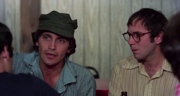 Movie still from “I Spit on Your Grave” (1978), directed by Meir Zarchi – Two men sitting next to each other in a room; Close Up shot, Over the shoulder angle