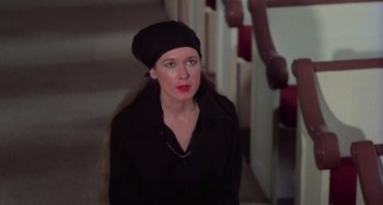 Movie still from “I Spit on Your Grave” (1978), directed by Meir Zarchi – A woman in a black shirt and a black hat; Close Up shot, High angle