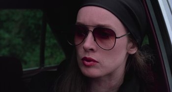 Movie still from “I Spit on Your Grave” (1978), directed by Meir Zarchi – A person wearing a hat and sunglasses; Close Up shot, Low angle
