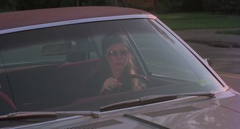 Movie still from “I Spit on Your Grave” (1978), directed by Meir Zarchi – A woman sitting in the driver's seat of a car; Medium shot, High angle