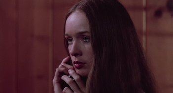 Movie still from “I Spit on Your Grave” (1978), directed by Meir Zarchi – A beautiful young woman with long brown hair and green eyes; Close Up shot, Low angle