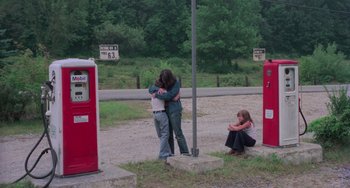 Movie still from “I Spit on Your Grave” (1978), directed by Meir Zarchi – Two people hugging on the side of the road; Wide shot, High angle