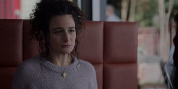 Movie still from “I Want You Back” (2022), directed by Jason Orley – A woman sitting on a couch looking sad; Close Up shot, Over the shoulder angle