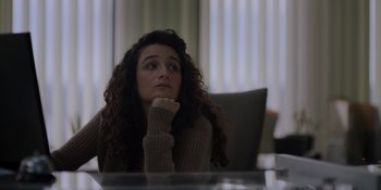 Movie still from “I Want You Back” (2022), directed by Jason Orley – A woman sitting at a table with her hand under her chin; Close Up shot, Over the shoulder angle