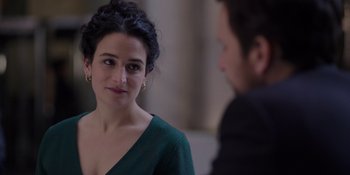 Movie still from “I Want You Back” (2022), directed by Jason Orley – A woman in a green dress looking at a man in a black suit; Close Up shot, Over the shoulder angle