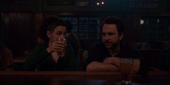 Movie still from “I Want You Back” (2022), directed by Jason Orley – A man and a woman sitting at a table with a beer; Medium shot, Over the shoulder angle