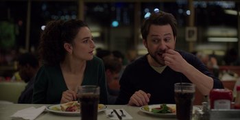 Movie still from “I Want You Back” (2022), directed by Jason Orley – A man and a woman sitting in front of a plate of food; Medium shot, Over the shoulder angle