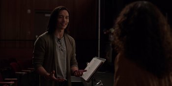 Movie still from “I Want You Back” (2022), directed by Jason Orley – A man standing in front of a sheet music stand; Medium shot, Over the shoulder angle