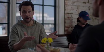 Movie still from “I Want You Back” (2022), directed by Jason Orley – A group of people sitting at a table with food; Medium shot, Over the shoulder angle