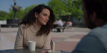 Movie still from “I Want You Back” (2022), directed by Jason Orley – A woman sitting at an outdoor table with a cup of coffee; Close Up shot, Over the shoulder angle