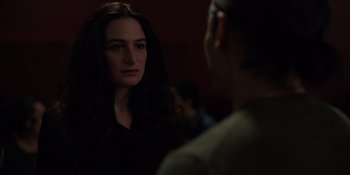 Movie still from “I Want You Back” (2022), directed by Jason Orley – A woman looking at a man in a dark room; Close Up shot, Over the shoulder angle