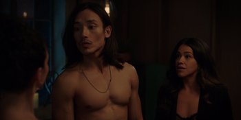 Movie still from “I Want You Back” (2022), directed by Jason Orley – A man with long black hair standing next to a woman; Medium shot, Over the shoulder angle