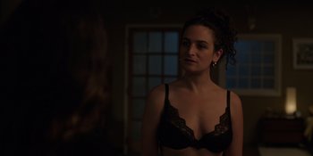 Movie still from “I Want You Back” (2022), directed by Jason Orley – A woman in a black bra stands in front of a window; Close Up shot, Over the shoulder angle