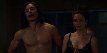 Movie still from “I Want You Back” (2022), directed by Jason Orley – A man and a woman standing next to each other; Medium shot, Over the shoulder angle