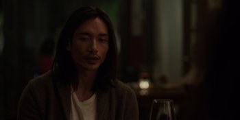 Movie still from “I Want You Back” (2022), directed by Jason Orley – A man sitting in front of a glass of wine; Close Up shot, Over the shoulder angle