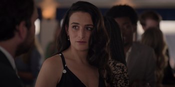 Movie still from “I Want You Back” (2022), directed by Jason Orley – A woman in a black dress is looking at the camera; Close Up shot, Over the shoulder angle