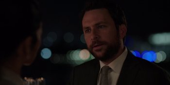 Movie still from “I Want You Back” (2022), directed by Jason Orley – A person wearing a suit and tie; Close Up shot, Over the shoulder angle