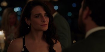 Movie still from “I Want You Back” (2022), directed by Jason Orley – A woman with long dark hair wearing a black dress; Close Up shot, Over the shoulder angle