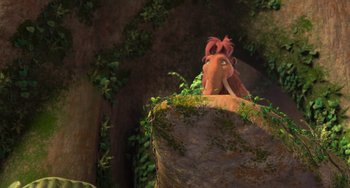 Movie still from “Ice Age: Dawn of the Dinosaurs” (2009), directed by Michael Thurmeier – An animated scene of an animal sitting on top of a tree stump; Wide shot, Overhead angle