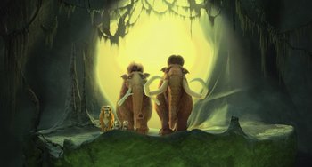 Movie still from “Ice Age: Dawn of the Dinosaurs” (2009), directed by Michael Thurmeier – Two wooly mammoths and a baby mammoth in a forest; Wide shot, Low angle