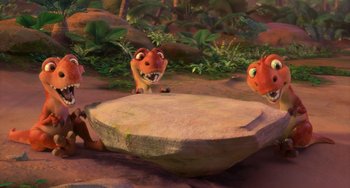 Movie still from “Ice Age: Dawn of the Dinosaurs” (2009), directed by Michael Thurmeier – A group of animals that are sitting in the dirt; Wide shot, High angle