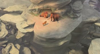 Movie still from “Ice Age: Dawn of the Dinosaurs” (2009), directed by Michael Thurmeier – A couple of animals sitting on top of a cliff; Wide shot, Overhead angle