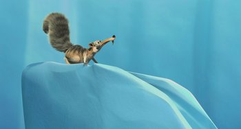 Movie still from “Ice Age: The Meltdown” (2006), directed by Carlos Saldanha – An animated squirrel holding something in its mouth; Wide shot, Low angle
