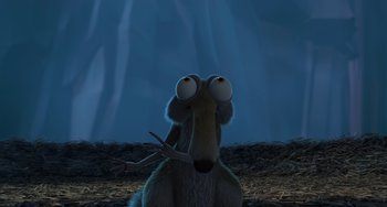 Movie still from “Ice Age: The Meltdown” (2006), directed by Carlos Saldanha – An animal with big eyes is sitting in the dirt; Medium shot, High angle