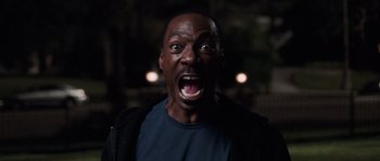 Movie still from “Imagine That” (2009), directed by Karey Kirkpatrick – A man with his mouth wide open in the dark; Close Up shot, High angle