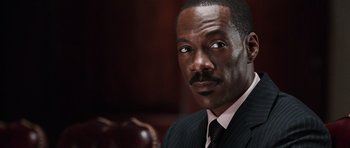 Movie still from “Imagine That” (2009), directed by Karey Kirkpatrick – A person wearing a suit and tie; Close Up shot, Low angle