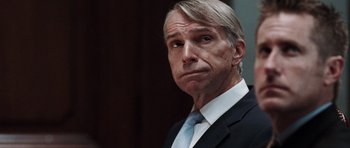 Movie still from “Imagine That” (2009), directed by Karey Kirkpatrick – A person wearing a suit and tie; Close Up shot, Over the shoulder angle