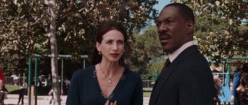 Movie still from “Imagine That” (2009), directed by Karey Kirkpatrick – A man and a woman standing next to each other outside; Close Up shot, Over the shoulder angle