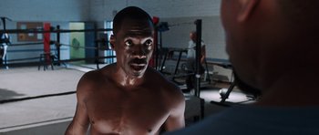 Movie still from “Imagine That” (2009), directed by Karey Kirkpatrick – A man that is in the gym; Close Up shot, Over the shoulder angle