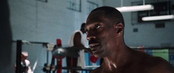 Movie still from “Imagine That” (2009), directed by Karey Kirkpatrick – A man that is in the gym looking up; Close Up shot, Over the shoulder angle
