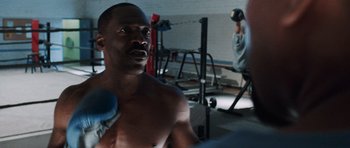 Movie still from “Imagine That” (2009), directed by Karey Kirkpatrick – A man that is in the gym; Medium shot, Over the shoulder angle