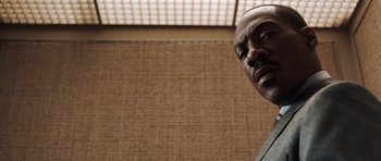 Movie still from “Imagine That” (2009), directed by Karey Kirkpatrick – A man's face in front of a brown wall; Close Up shot, Low angle